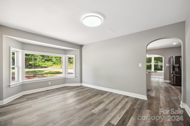 unfurnished room featuring hardwood / wood-style flooring