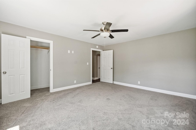 unfurnished bedroom featuring carpet flooring, a closet, and ceiling fan