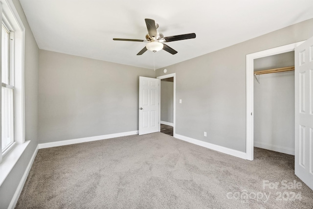 unfurnished bedroom with carpet flooring, ceiling fan, and a closet