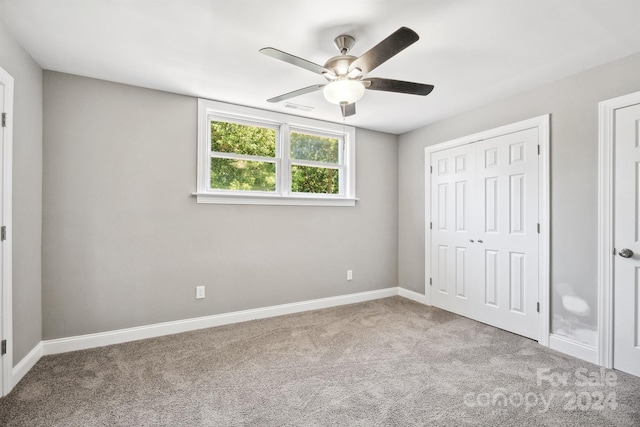 unfurnished bedroom with ceiling fan and light colored carpet