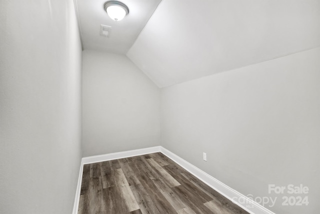 additional living space featuring hardwood / wood-style flooring and vaulted ceiling