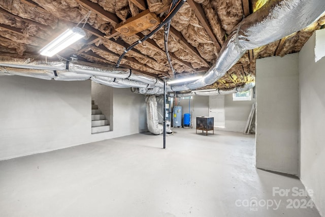 basement featuring heating unit and water heater