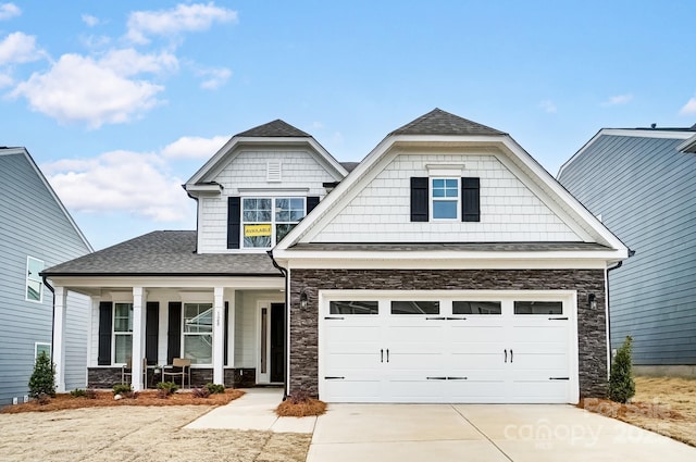 craftsman inspired home featuring a garage and covered porch