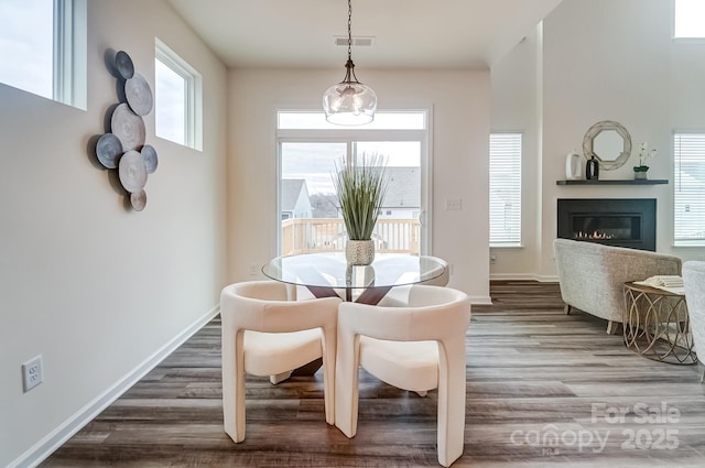 dining space with hardwood / wood-style floors