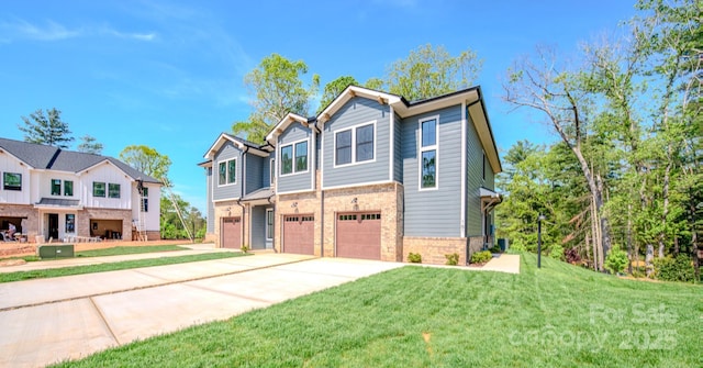 167 Collin Pl Unit 21, Asheville, NC 28804 - view of front of home with concrete driveway, a front yard, brick siding, and a garage