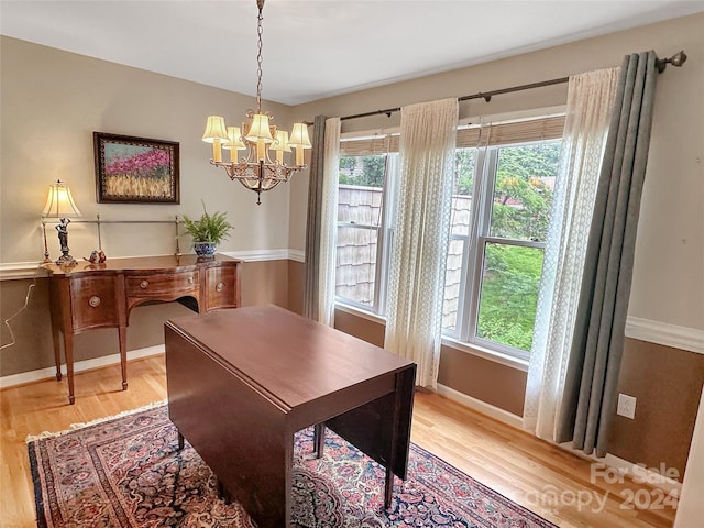 dining space featuring an inviting chandelier and wood-type flooring