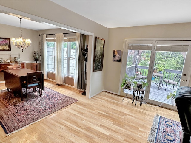 dining room with an inviting chandelier and light hardwood / wood-style flooring