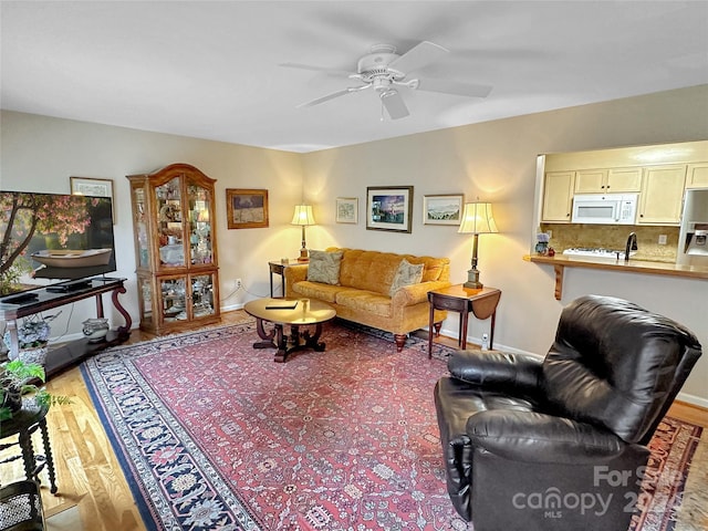 living room with hardwood / wood-style flooring and ceiling fan