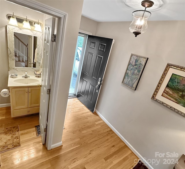 hall featuring sink and light hardwood / wood-style flooring