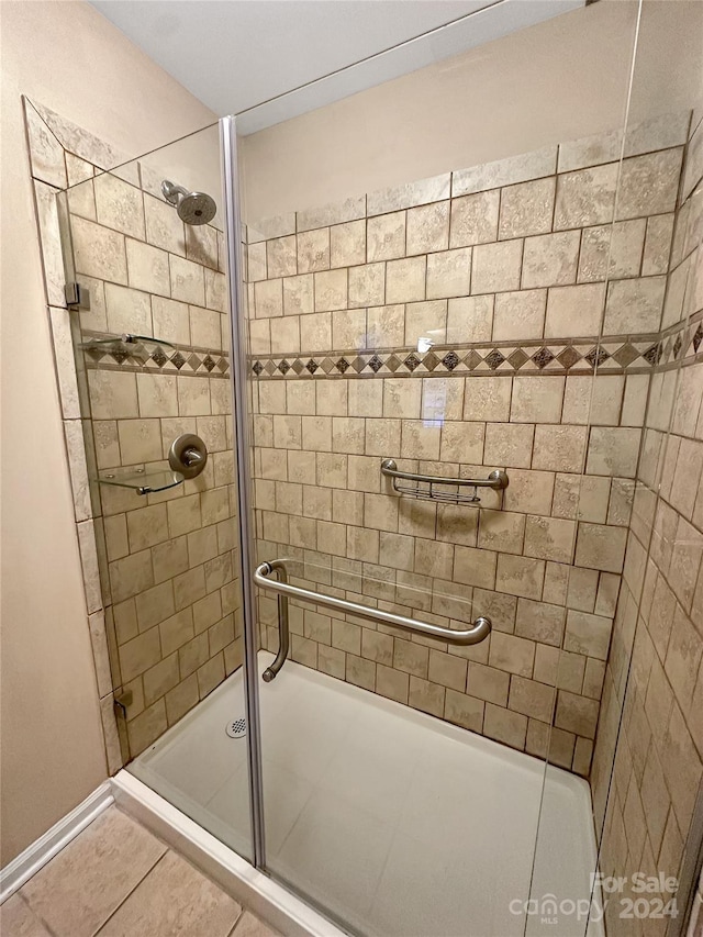 bathroom featuring a shower with shower door