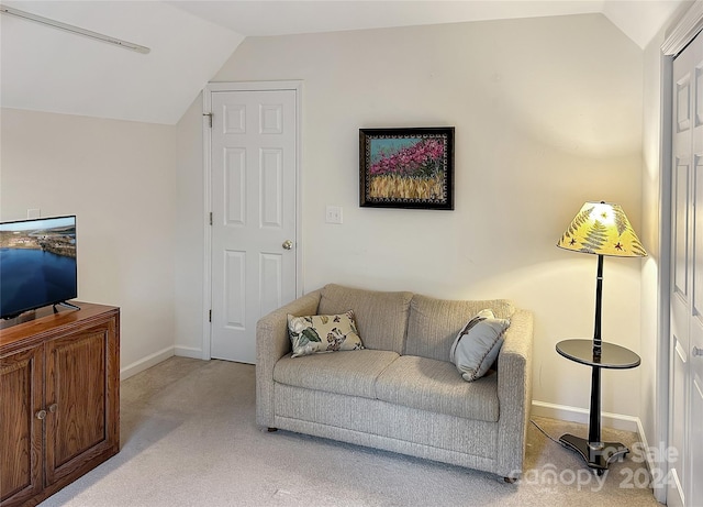 living room with light colored carpet and lofted ceiling