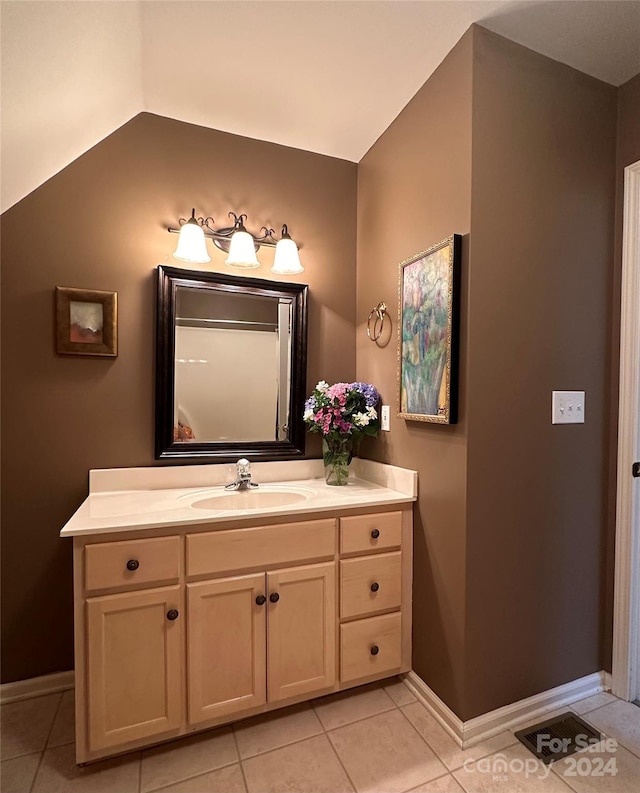 bathroom with tile patterned floors and vanity