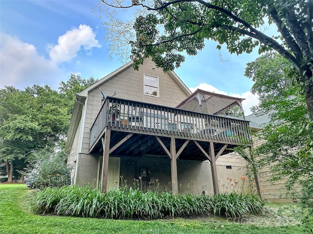 rear view of house featuring a wooden deck