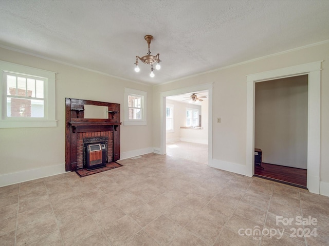 living room featuring crown molding, a notable chandelier, and a textured ceiling