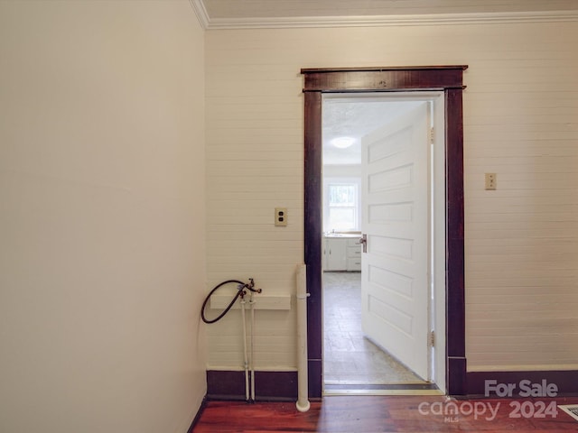 hall with hardwood / wood-style flooring and crown molding