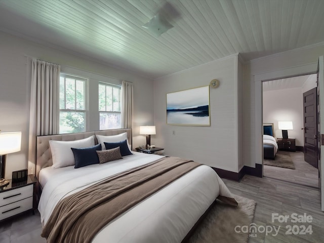 bedroom with hardwood / wood-style flooring and ornamental molding