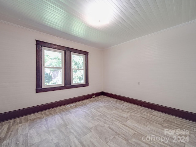 spare room with crown molding