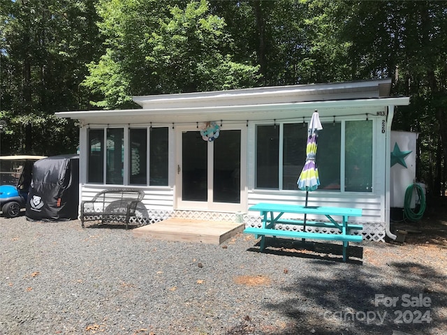 back of property featuring a sunroom