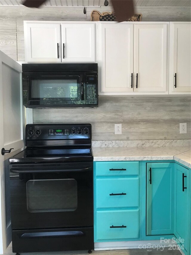 kitchen with light stone countertops, white cabinetry, blue cabinets, decorative backsplash, and black appliances