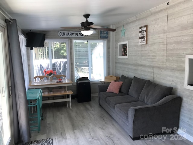 living room with ceiling fan and hardwood / wood-style flooring