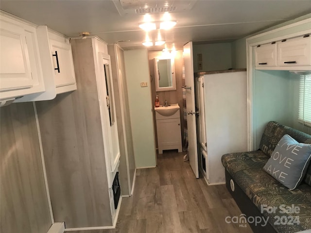 interior space with hardwood / wood-style floors and sink