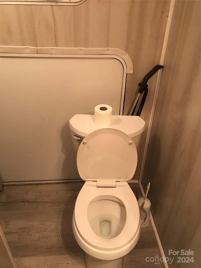 bathroom with hardwood / wood-style floors and toilet