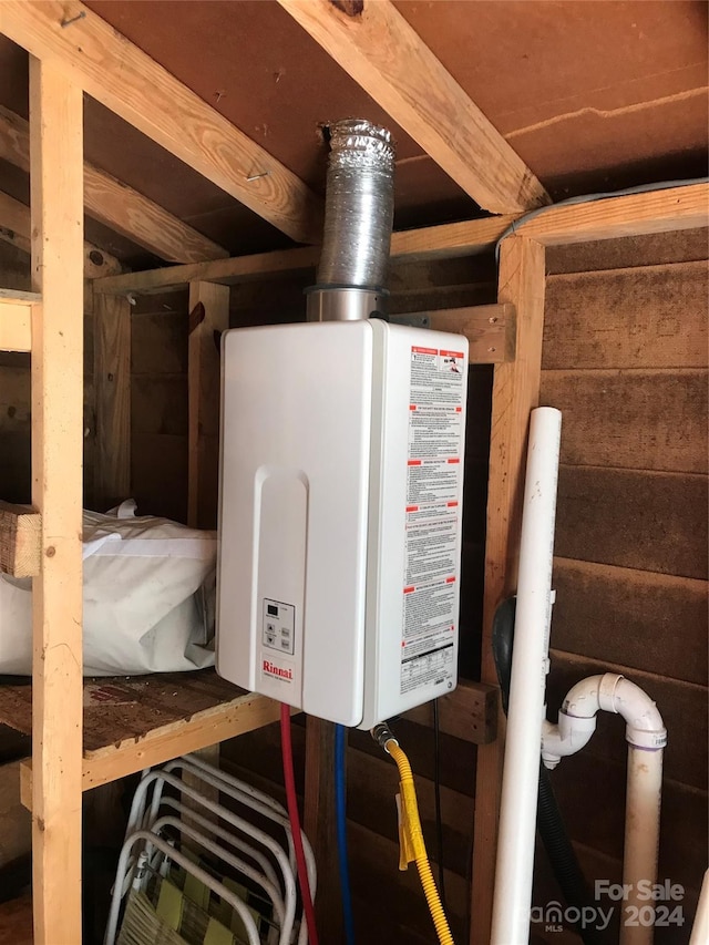 utility room featuring tankless water heater