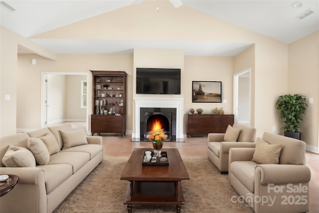 living room with vaulted ceiling, visible vents, and a warm lit fireplace