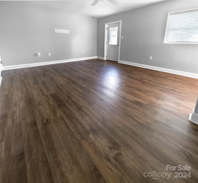 spare room with ceiling fan and dark hardwood / wood-style floors