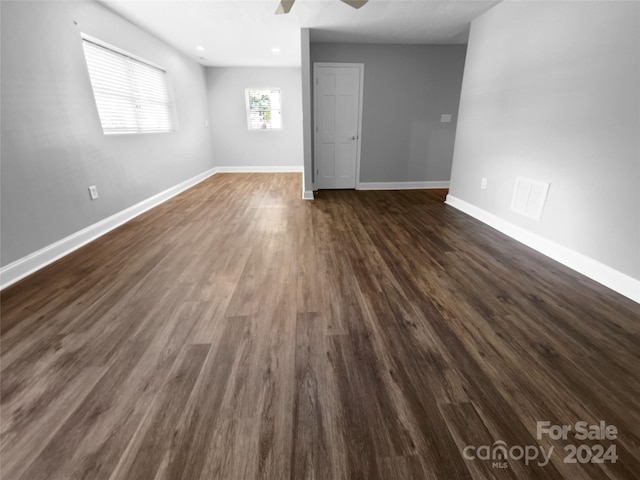 unfurnished room with dark hardwood / wood-style floors and ceiling fan