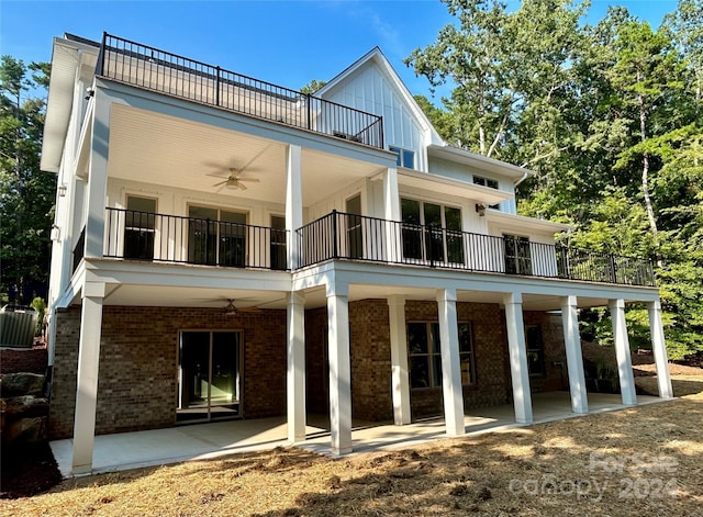 rear view of house featuring brick siding, a patio area, ceiling fan, a balcony, and cooling unit