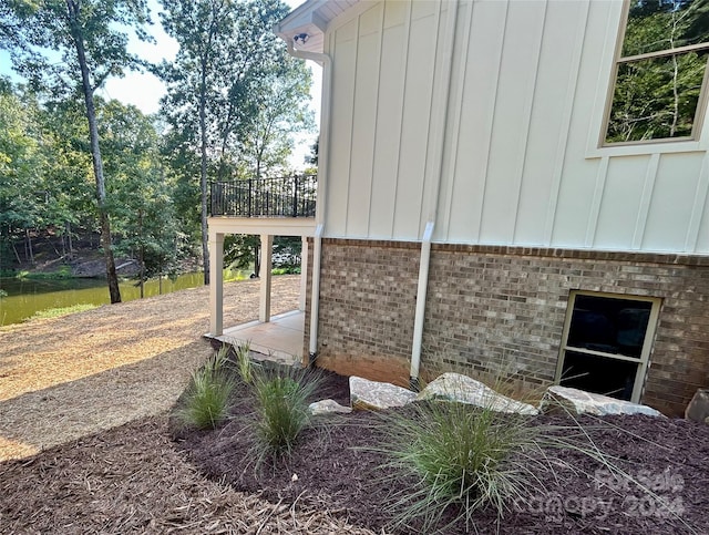 view of side of home with board and batten siding and brick siding