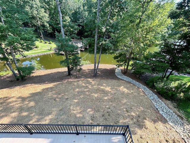 view of yard with a dock and a water view