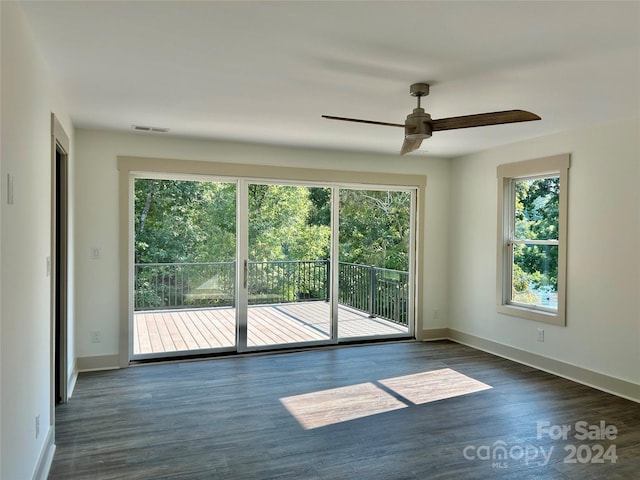 unfurnished room featuring visible vents, baseboards, a wealth of natural light, and wood finished floors