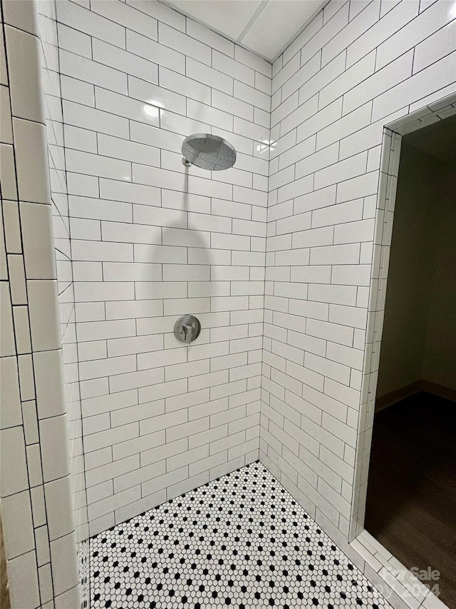 full bath featuring tiled shower