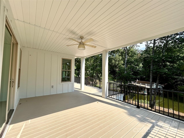 wooden deck featuring a ceiling fan