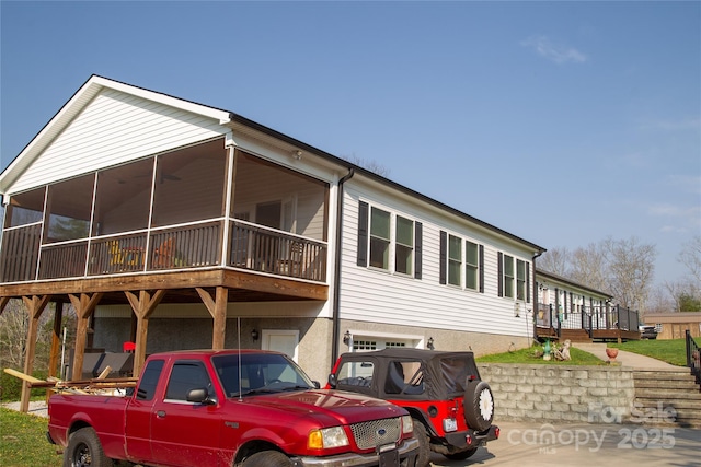 view of front facade featuring a sunroom and an attached garage