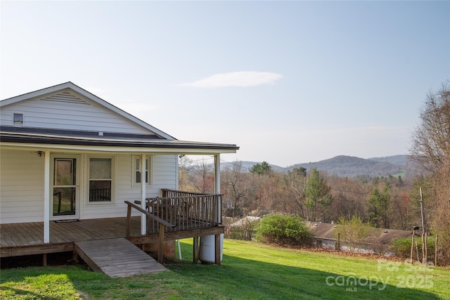 exterior space with a deck with mountain view