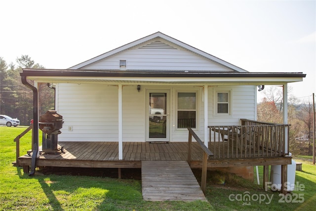 rear view of property with a yard