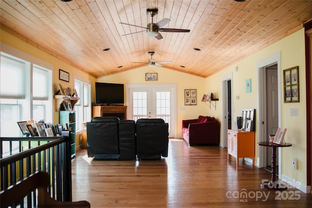 living room featuring lofted ceiling, french doors, wooden ceiling, and wood finished floors