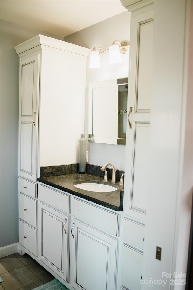 bathroom featuring tile patterned flooring and vanity