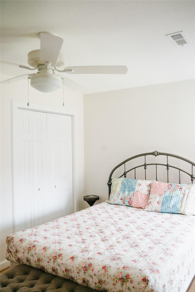 bedroom with a closet, visible vents, and a ceiling fan