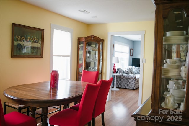 dining room featuring wood finished floors and visible vents