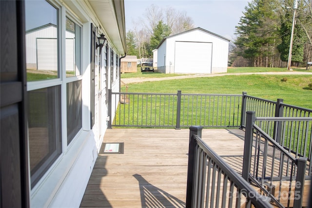 deck with an outbuilding, a lawn, and a detached garage