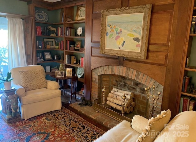 living area with a fireplace and wood walls