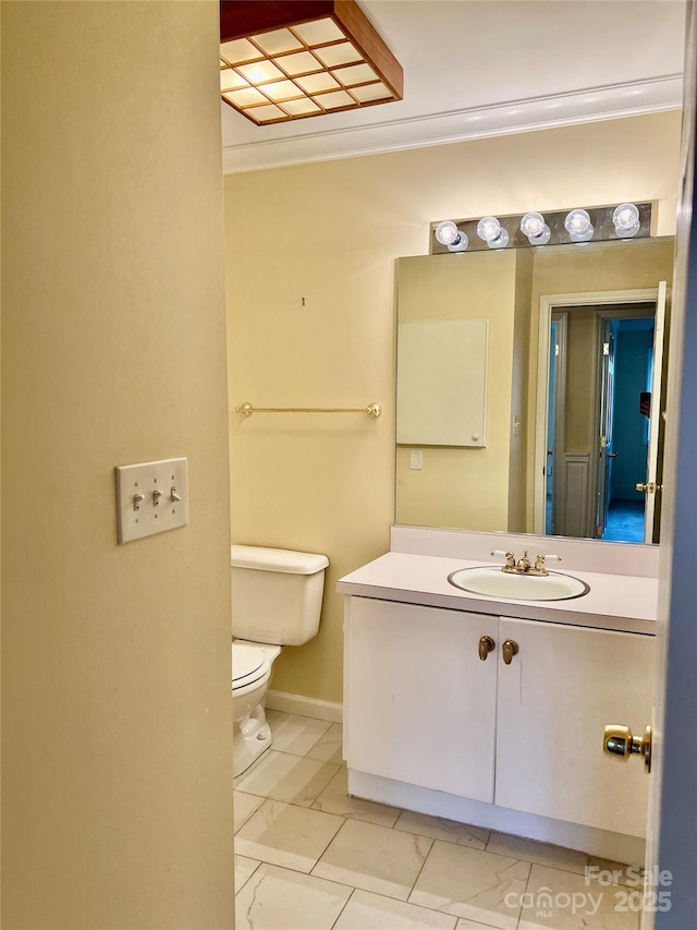 bathroom featuring toilet, vanity, ornamental molding, and tile patterned flooring