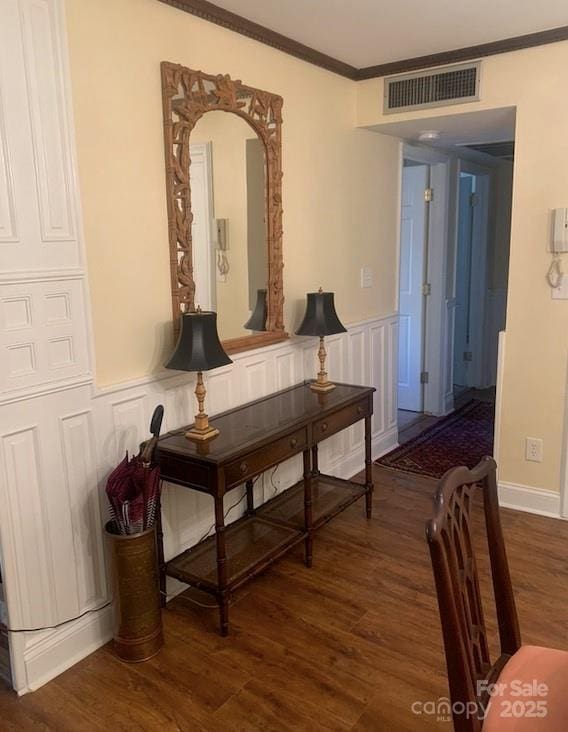 hall featuring dark hardwood / wood-style flooring and crown molding