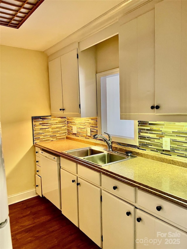 kitchen featuring white cabinetry, tasteful backsplash, dark hardwood / wood-style flooring, dishwasher, and sink