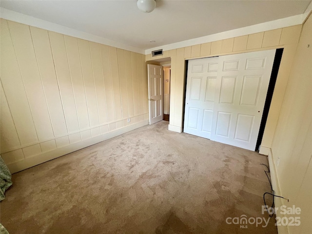 unfurnished bedroom with carpet and a closet