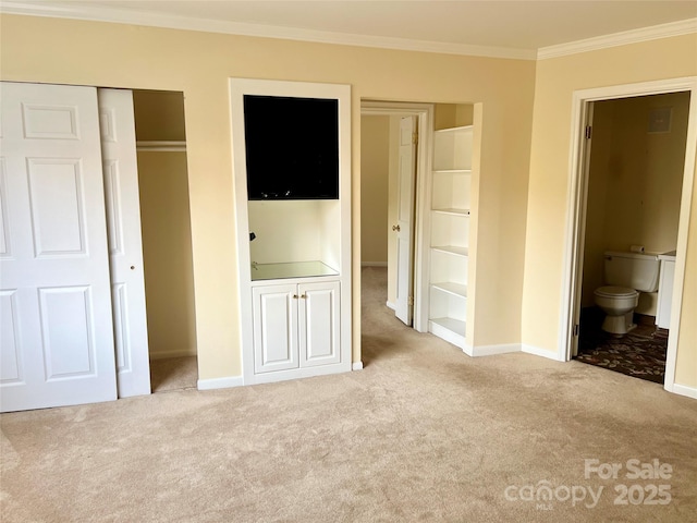 unfurnished bedroom with light carpet, ensuite bathroom, and ornamental molding